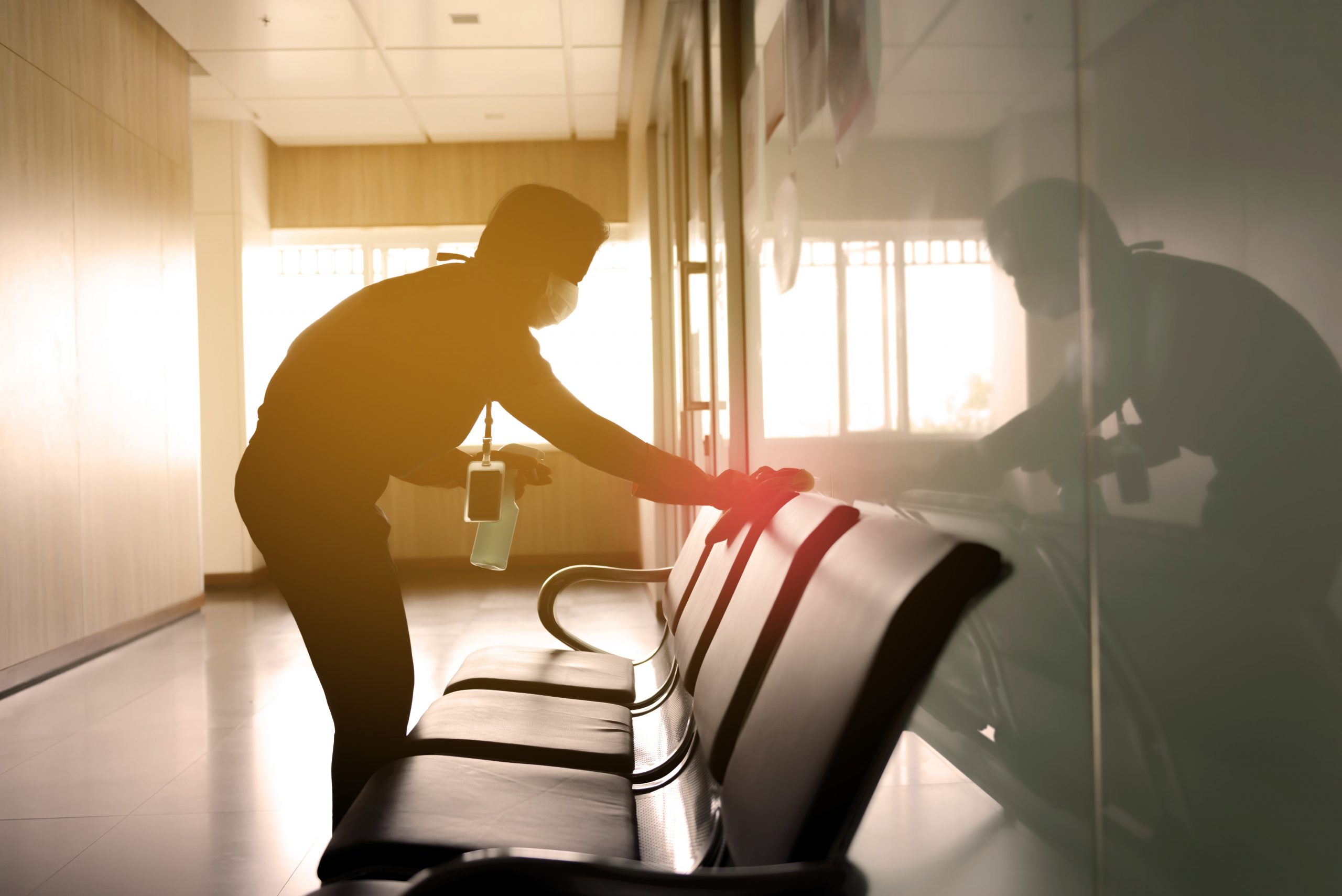 blog image of a worker disinfecting an office space